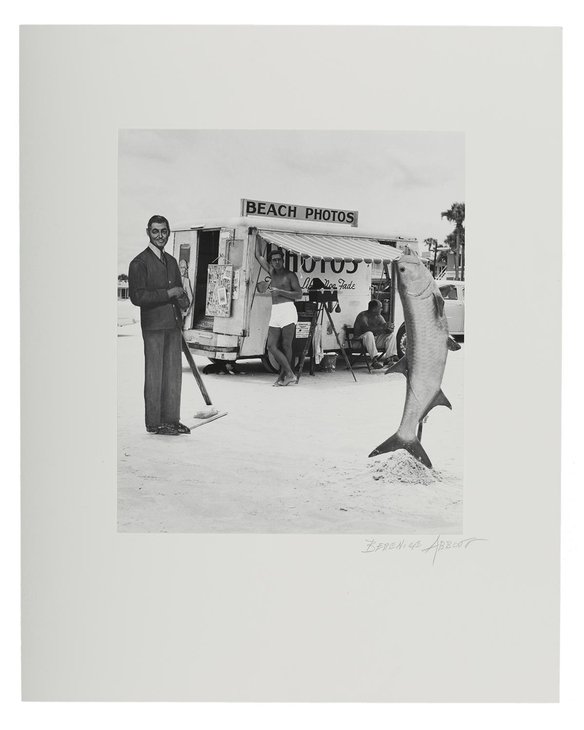 A photo of a man next to a giant fish added in post-production on a beach in Florida from 1954.