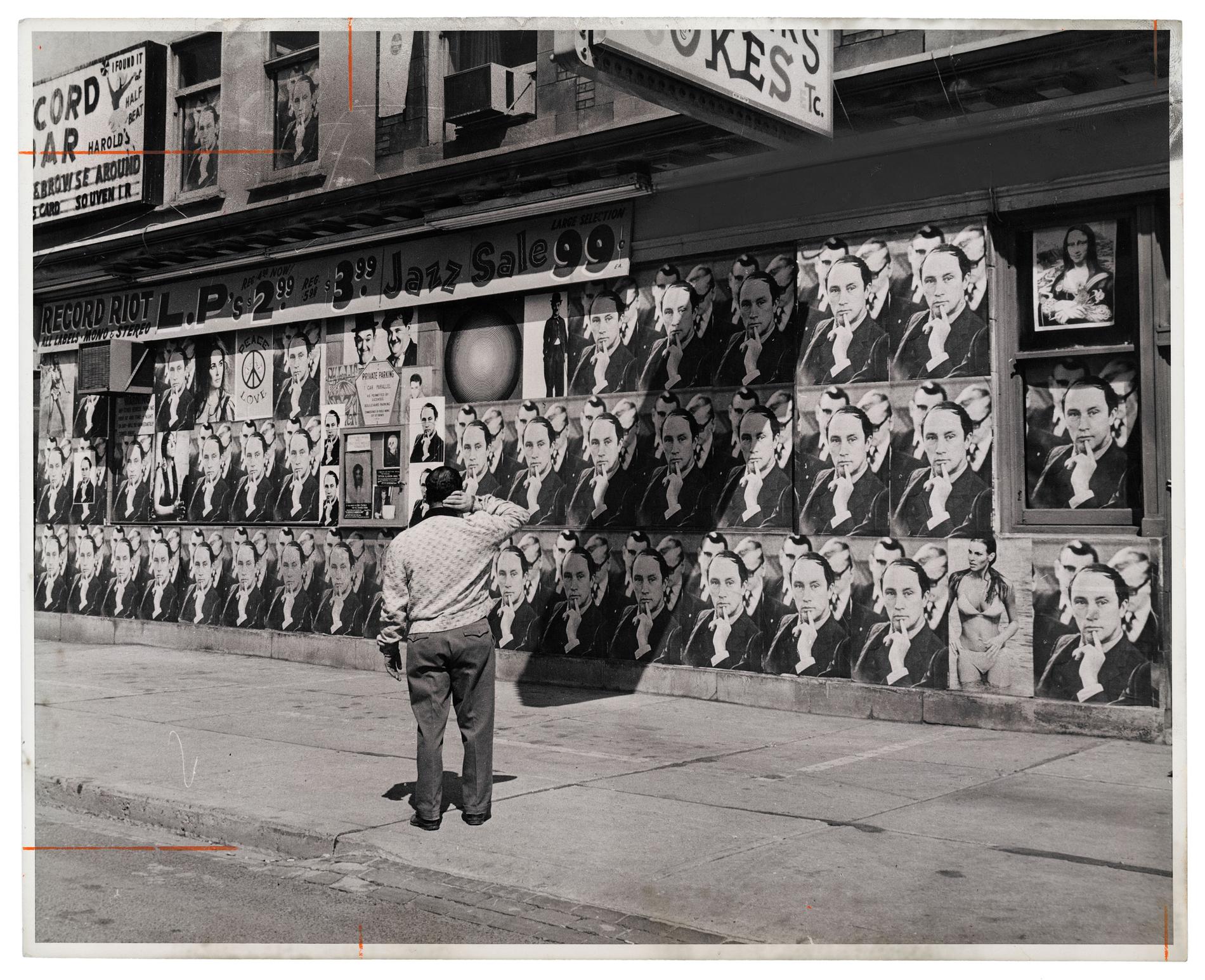 Man stares at a wall of posters with Trudeau's face in 1968.