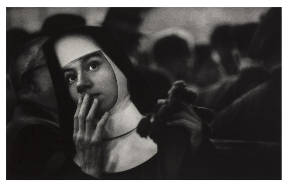 Photo of a nun holding her hand to her mouth in surprise.