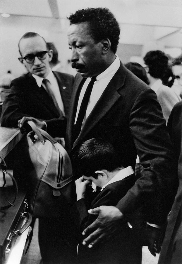 Gordon parks comforting and holding the young boy, Flávio