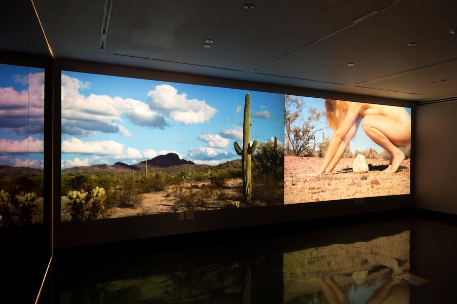 Two video stills. On the left: a desert landscape. On the right: a naked woman leans over a rock
