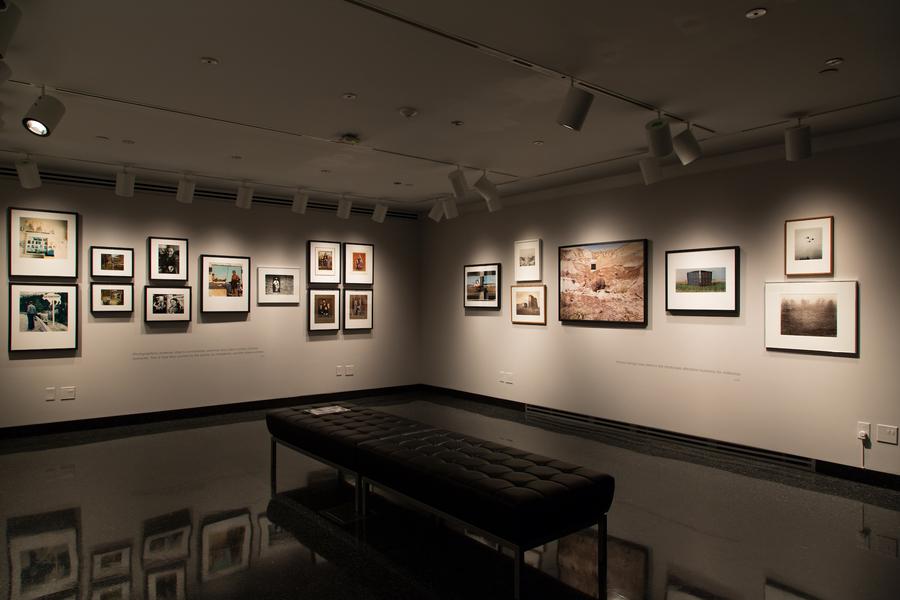 Wide shot of the student gallery with a black bench in the middle