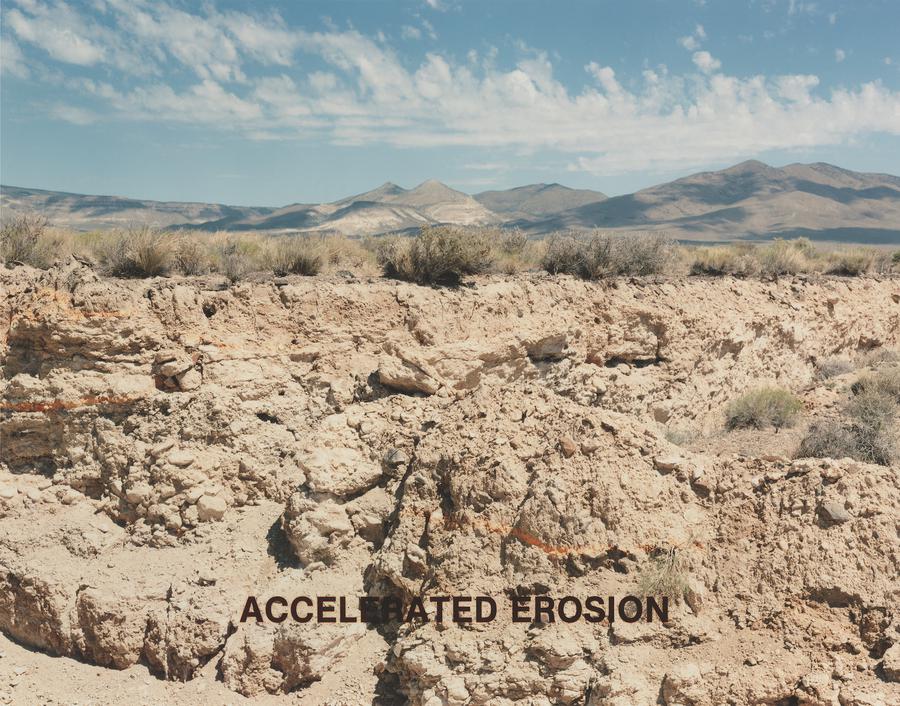 A desert with mountains in the distance, text in foreground reads "Accelerated Erosion"