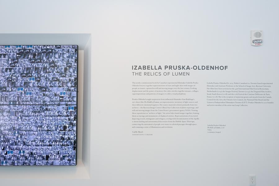 Hundreds of tiny images overlapping on two screens, text beside reads "Izabella Pruska-Oldenhof. The Relics of Lumen"