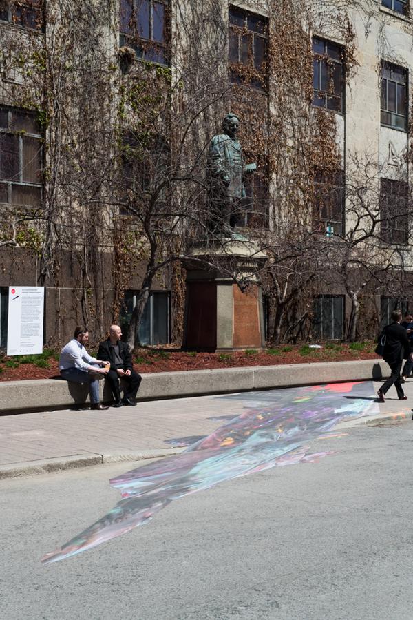 A colourful mural on the pavement reflecting the Egerton Ryerson statue