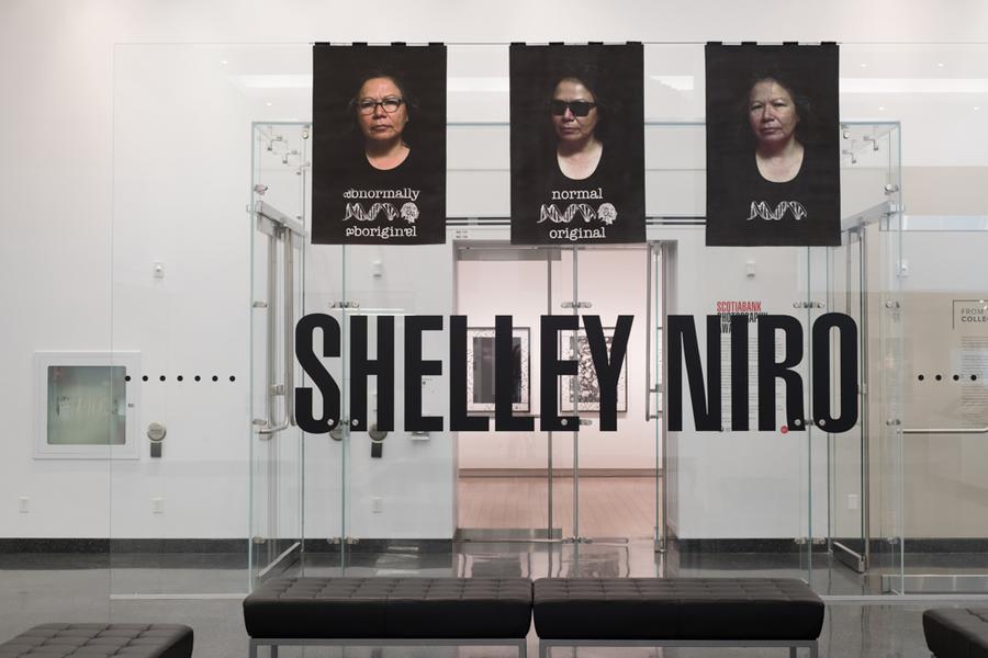3 photographs draped over a glass wall with Shelley Niro written underneath