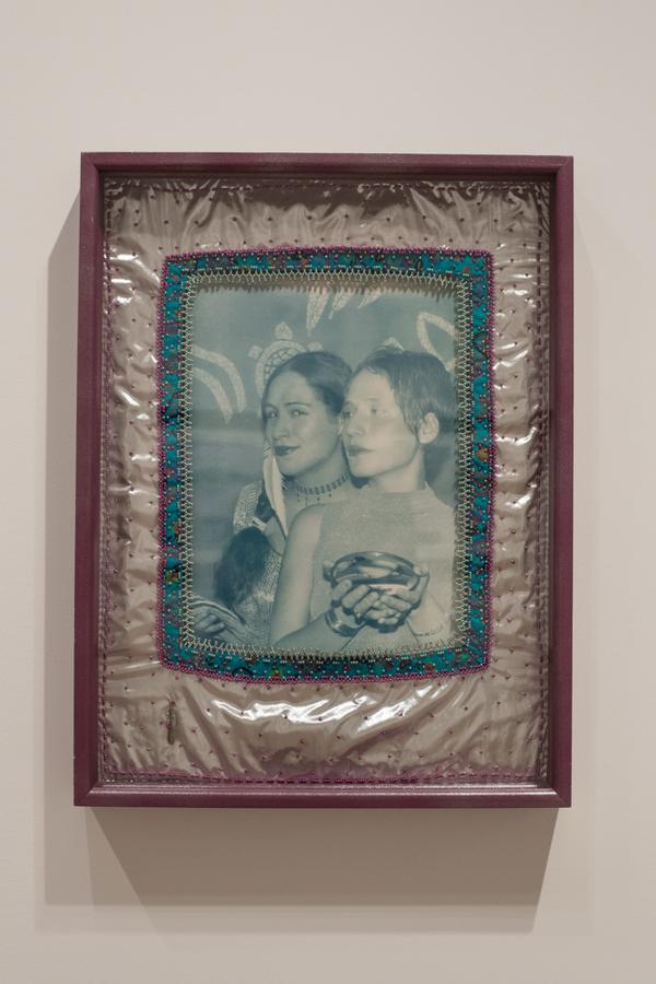 A photo of two girls with a metallic frame