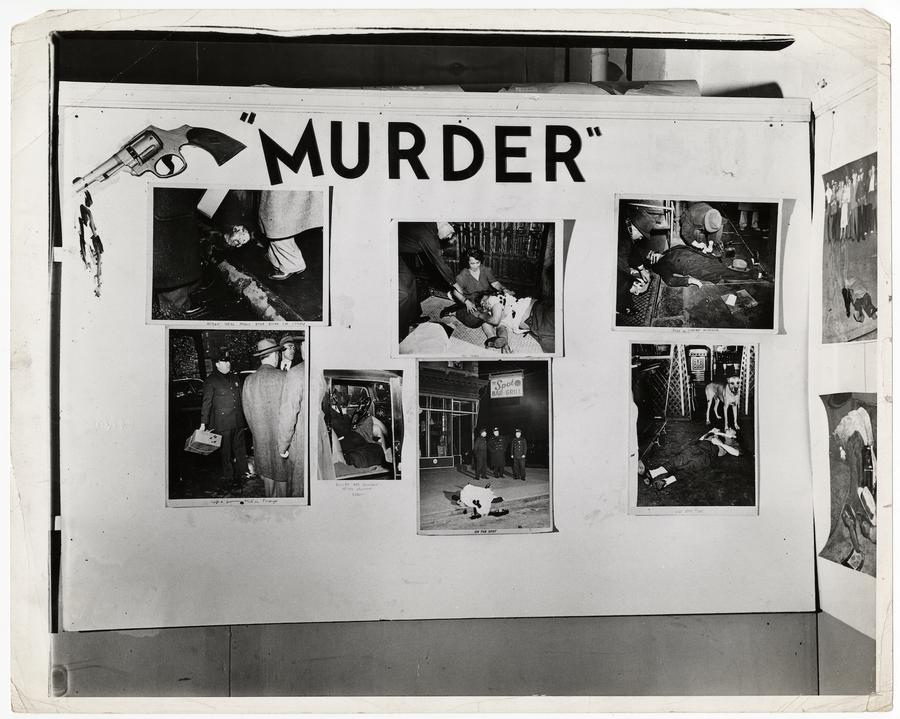 A presentation board with images tacked to it. An image of a gun in the top left corner, and the word 'Murder' in black letters in the center
