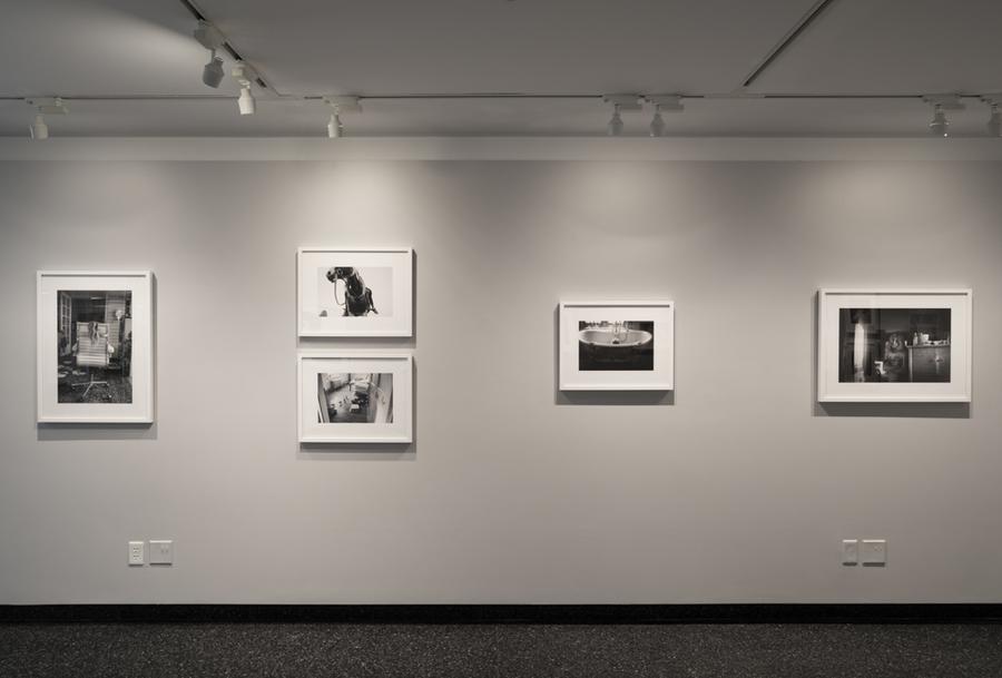 5 framed photographs hanging on a gallery wall