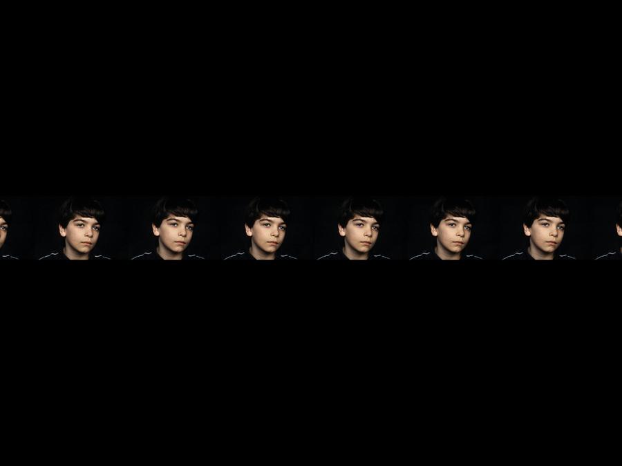 Six identical faces on a black background