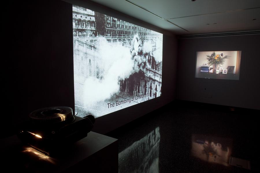 Two video stills in a dark room. On-screen text reads "The bombing of La Moneda"