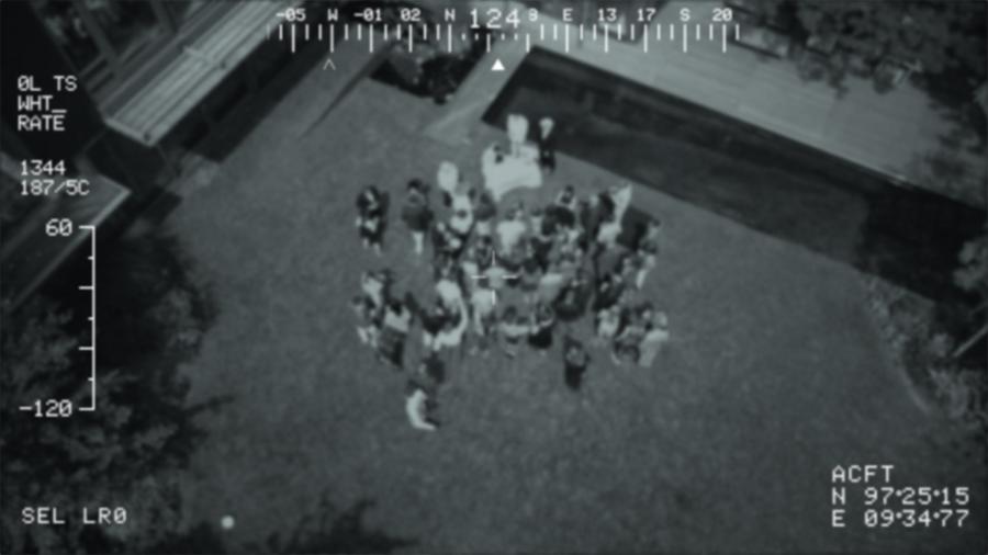 Drone photo of a group of people in a yard at night