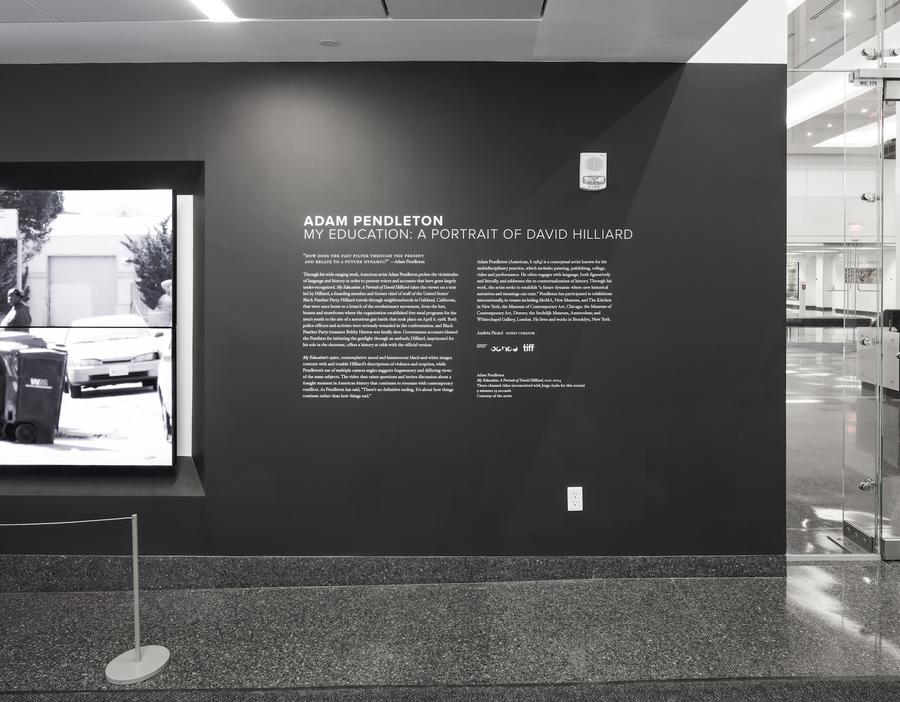 White text on a black wall that reads "Adam Pendleton: My Education: A Portrait of David Hilliard"