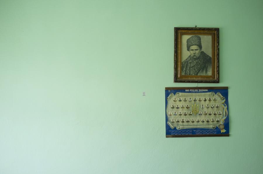 Two framed photographs on a turquoise wall