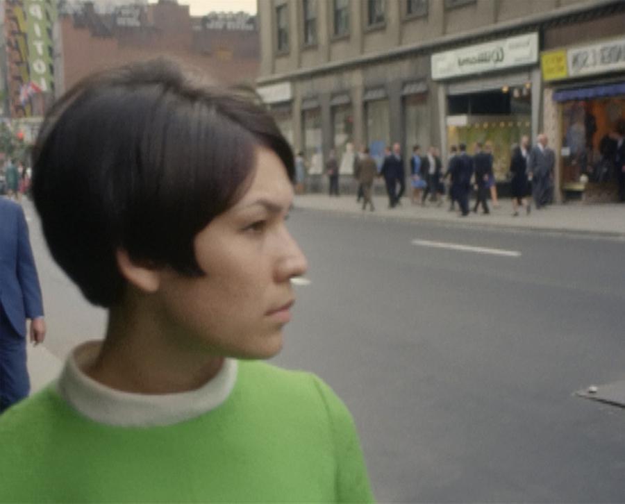 A woman with short hair wearing a green sweater