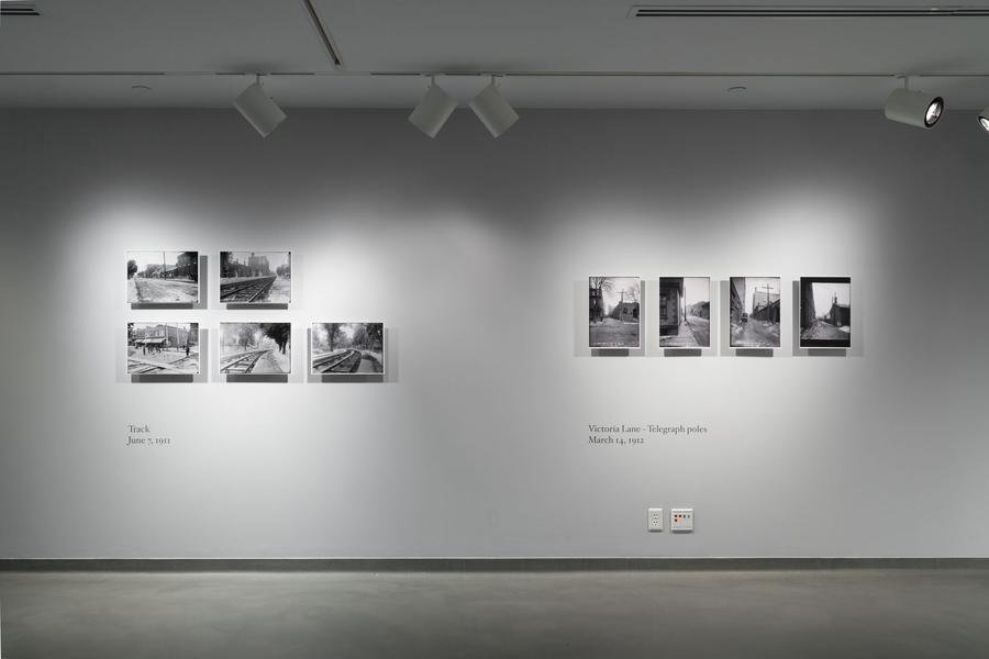 A gallery wall with 9 photographs framed and hanging
