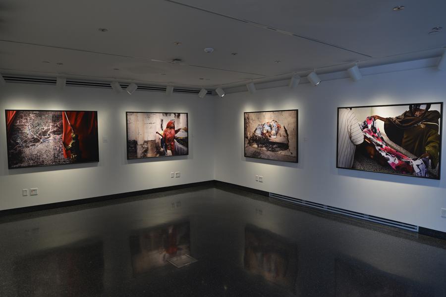 Wide shot of the Student Gallery, displaying four large photographs