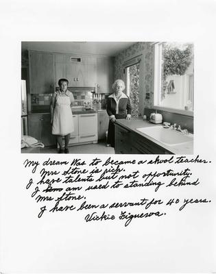 Two people posing in a kitchen